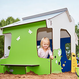 Girl playing on a playground play house